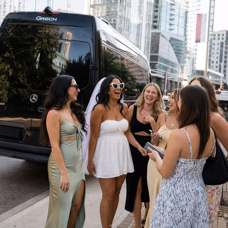 Group boarding a white charter bus for Bachelor & Bachelorette Transportation transportation in Austin