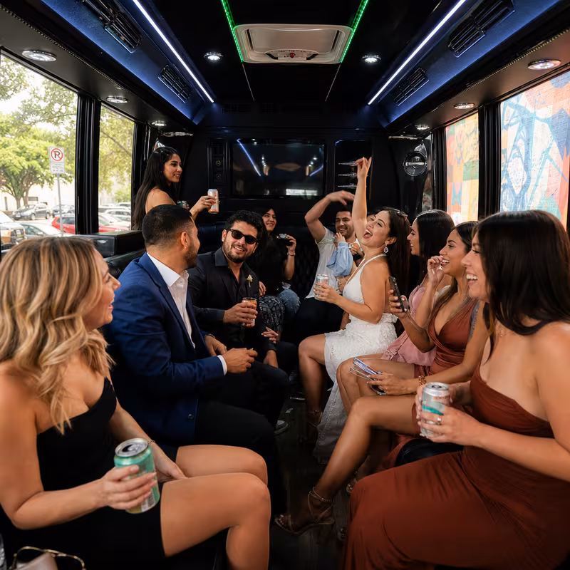 Party bus interior with wraparound leather seating and LED lighting in Austin