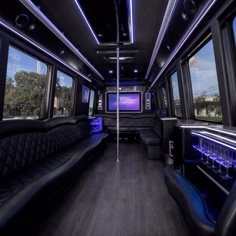 Party bus interior with wraparound leather seating and LED lighting in Austin