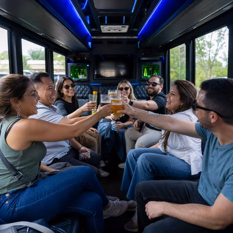 Group boarding a white charter bus for Winery & Brewery Tour Transportation transportation in Austin
