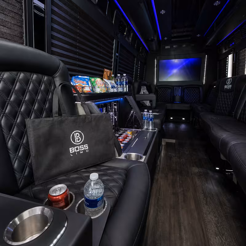 Party bus interior with wraparound leather seating and LED lighting in Austin