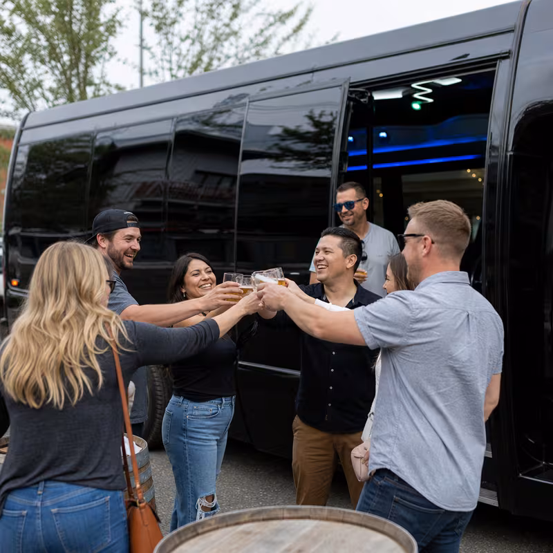 Passengers loading luggage while boarding an Austin group shuttle